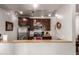 Galley kitchen featuring stainless steel appliances and track lighting at 14145 N 92Nd St # 1158, Scottsdale, AZ 85260