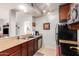 Kitchen featuring granite countertops, stainless steel appliances, and dark wood cabinets at 14145 N 92Nd St # 1158, Scottsdale, AZ 85260