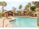 Community pool area with palm trees, lounge chairs, and an outdoor kitchen under a shaded structure at 14145 N 92Nd St # 1158, Scottsdale, AZ 85260