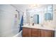 Bright bathroom with double sink vanity, tiled tub, and updated fixtures at 15024 N 142Nd Ln, Surprise, AZ 85379