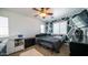 Comfortable bedroom with two windows, a ceiling fan and decorative wall and a bed at 15024 N 142Nd Ln, Surprise, AZ 85379