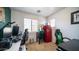 Cozy bedroom with a red mini fridge, neutral walls, and ample natural light at 15024 N 142Nd Ln, Surprise, AZ 85379