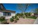 Landscaped front yard with mature trees and manicured bushes at 15024 N 142Nd Ln, Surprise, AZ 85379