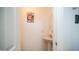 Convenient half bathroom with pedestal sink and neutral decor at 15024 N 142Nd Ln, Surprise, AZ 85379