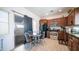 Bright kitchen includes stainless steel appliances, wooden cabinets, and access to outdoor patio at 15024 N 142Nd Ln, Surprise, AZ 85379