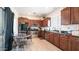 Well-lit kitchen featuring brown cabinetry, stainless steel appliances, and a cozy breakfast nook at 15024 N 142Nd Ln, Surprise, AZ 85379
