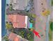 An aerial view of a tile roofed home with a sparkling pool, landscaped backyard, and desert surroundings at 15954 W Sheila Ln, Goodyear, AZ 85395