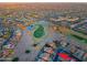Scenic aerial view of the community, featuring a golf course, shimmering ponds, and beautiful homes at 15954 W Sheila Ln, Goodyear, AZ 85395