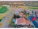 Beautiful sunset aerial view of a tile roof home with a pool, desert landscape, and palm trees at 15954 W Sheila Ln, Goodyear, AZ 85395