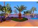 Lush backyard showcases tropical plants, swimming pool and golf course views at 15954 W Sheila Ln, Goodyear, AZ 85395