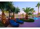 Backyard with pool, golf course views, tropical plants and lounge chairs at 15954 W Sheila Ln, Goodyear, AZ 85395
