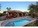 Backyard featuring a pool, outdoor furniture, built-in grill and lush landscaping at 15954 W Sheila Ln, Goodyear, AZ 85395
