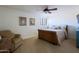 Bright bedroom featuring neutral carpet, tan walls, shuttered window, ceiling fan and comfortable furniture at 15954 W Sheila Ln, Goodyear, AZ 85395