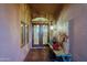 Inviting entryway featuring decorative double doors, an art niche, and custom lighting at 15954 W Sheila Ln, Goodyear, AZ 85395