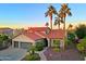 Charming single-Gathering home showcasing desert landscaping, a tile roof, and three-car garage at 15954 W Sheila Ln, Goodyear, AZ 85395