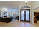 Open concept living space with decorative front door and a view to the Gathering room at 15954 W Sheila Ln, Goodyear, AZ 85395