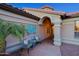 Inviting home featuring a cozy front porch setting with chairs and a decorative table at 15954 W Sheila Ln, Goodyear, AZ 85395