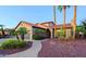 Beautiful home showcasing a three-car garage, an arched entryway, and mature landscaping with palm trees at 15954 W Sheila Ln, Goodyear, AZ 85395