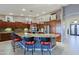 Well-appointed kitchen island with seating, stainless steel appliances, and custom cabinets providing lots of storage at 15954 W Sheila Ln, Goodyear, AZ 85395