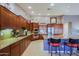 Spacious kitchen features custom cabinetry, stainless steel appliances, and a breakfast bar with seating at 15954 W Sheila Ln, Goodyear, AZ 85395