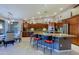 Large kitchen features a central island with seating, a view of an adjacent dining area and stainless appliances at 15954 W Sheila Ln, Goodyear, AZ 85395