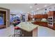 Gourmet kitchen with granite countertops, stainless appliances, and island seating overlooking backyard pool at 15954 W Sheila Ln, Goodyear, AZ 85395