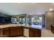 Open-concept design with kitchen island that flows into the living and dining areas, connecting indoor and outdoor living at 15954 W Sheila Ln, Goodyear, AZ 85395