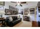Bright living room showcasing a comfortable sofa, decorative pillows, and golf memorabilia at 15954 W Sheila Ln, Goodyear, AZ 85395