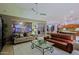 Inviting living room with comfortable sofas, a glass coffee table, and views of the backyard at 15954 W Sheila Ln, Goodyear, AZ 85395