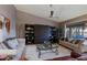 Bright and airy living room showcasing vaulted ceilings, comfortable seating, and custom shelving at 15954 W Sheila Ln, Goodyear, AZ 85395
