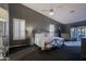 Spacious main bedroom boasts a wrought iron bed, sitting area, and ample natural light at 15954 W Sheila Ln, Goodyear, AZ 85395