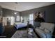 Elegantly appointed main bedroom with a sitting area, chandelier, and ample natural light at 15954 W Sheila Ln, Goodyear, AZ 85395