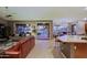 Open concept living space featuring a kitchen island, living area, and access to the outdoor patio and pool at 15954 W Sheila Ln, Goodyear, AZ 85395
