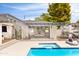Lush backyard featuring a pool, hot tub, outdoor seating, and an outdoor kitchen area with string lights at 1609 W State Ave, Phoenix, AZ 85021