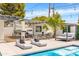 Inviting backyard with a pool, outdoor kitchen, covered seating area, and modern lounge furniture at 1609 W State Ave, Phoenix, AZ 85021