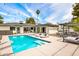 Spacious backyard with a pool, spa, various seating areas, and open access to the home's interior at 1609 W State Ave, Phoenix, AZ 85021