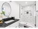 Modern bathroom features a tiled walk-in shower and a black marble countertop at 1609 W State Ave, Phoenix, AZ 85021