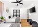 Bedroom featuring two beds with wood floors, and a ceiling fan at 1609 W State Ave, Phoenix, AZ 85021