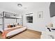 Bedroom with a bunk bed, wood floors, and a window offering plenty of natural light at 1609 W State Ave, Phoenix, AZ 85021