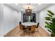 This modern dining room is illuminated by a unique chandelier and features stylish black display cabinets at 1609 W State Ave, Phoenix, AZ 85021