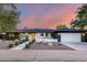 Charming single-story home features a yellow front door, well-manicured landscaping, and a two-car garage at 1609 W State Ave, Phoenix, AZ 85021