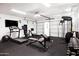 Home gym offers a variety of fitness equipment including a treadmill, weights, and punching bag at 1609 W State Ave, Phoenix, AZ 85021