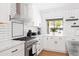 Modern kitchen with white cabinets, white subway tile, and stainless steel appliances at 1609 W State Ave, Phoenix, AZ 85021