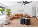 Spacious living area with a modern ceiling fan, comfortable leather seating and an open view to the pool area at 1609 W State Ave, Phoenix, AZ 85021