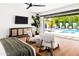 Bright main bedroom with a view of the pool, offering a seamless indoor-outdoor living experience at 1609 W State Ave, Phoenix, AZ 85021