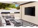 Well-appointed outdoor kitchen and lounge with a built-in grill and bar, plus a large television at 1609 W State Ave, Phoenix, AZ 85021
