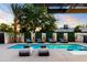 Backyard oasis with a sparkling pool, modern lounge chairs, and lush landscaping, perfect for relaxation at 1609 W State Ave, Phoenix, AZ 85021