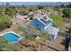 Aerial view of the home's pool, backyard, solar panels and landscaping at 16256 N 64Th Pl, Scottsdale, AZ 85254
