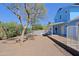 Spacious backyard with a covered patio, a pool with white fence and beautiful desert landscaping at 16256 N 64Th Pl, Scottsdale, AZ 85254