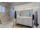 Bright bathroom with double sink vanity, marble shower, and modern fixtures exudes elegance at 16256 N 64Th Pl, Scottsdale, AZ 85254